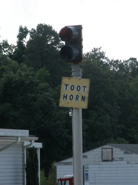 A sign to the truckers coming to load and unload at Atkinson's mill. It says toot horn.