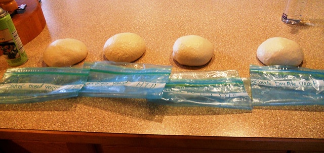 3 balls of bread dough on a counter.