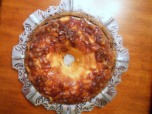 overhead photo of a pineapple upside down pound cake on a silver platter