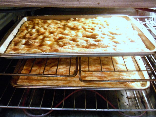 2 pans of Moravian sugar cake in the oven baking.