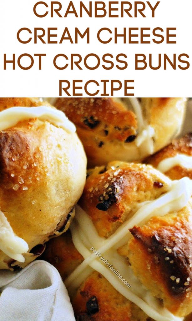 Close up view of hot cross buns. Text reads, "cranberry cream cheese hot cross buns recipe."