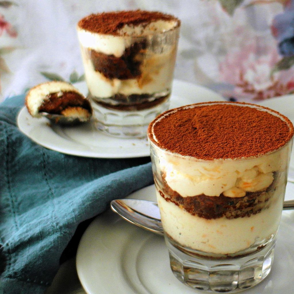 Two individual tiramisu made with chocolate ladyfinger sponge cake.