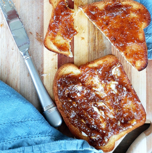 overhead shot of 2 slices of toast with butter and jam