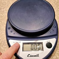 A closeup shot of a dark blue digital scale.