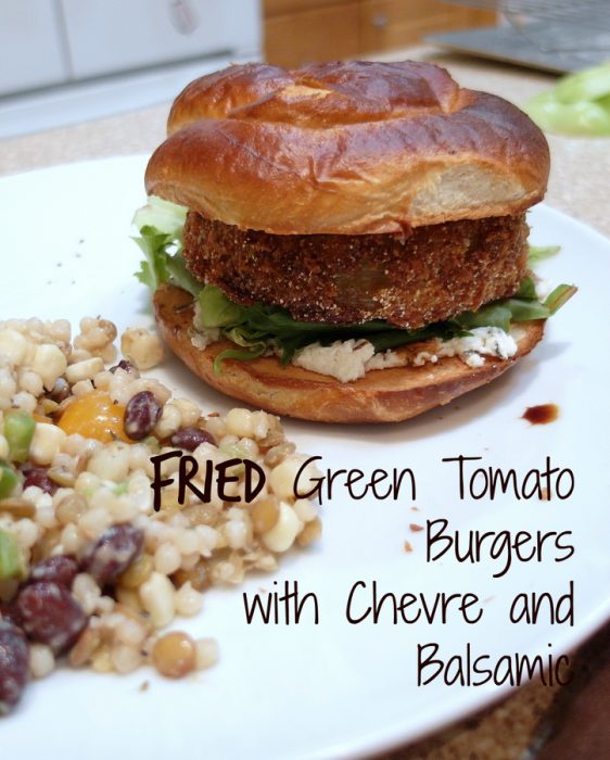 A fried green tomato "burger" on a bun withgoat cheese and lettuce.