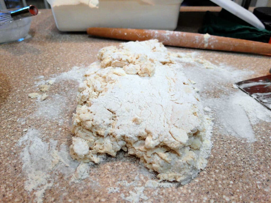 The biscuit dough rolled out at folded in half. It is still very messy and shaggy and has not really come together.