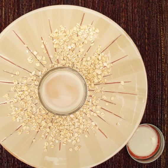 Overhead shot of a plate with dry oatmeal on it and a mason jar of vegan coffee creamer  in the center with the lid and ring next to the plate.