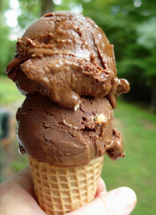 Two scoops of Vegan Mexican Chocolate Ice Cream in a waffle cone.
