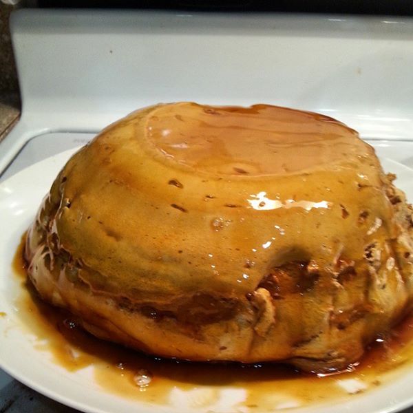 Photo of caramel coffee mousse right after being turned out of baking dish. Sauce is pooling around the base of the mousse.