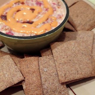 rye crackers with caraway seeds and a dish of reuben dip