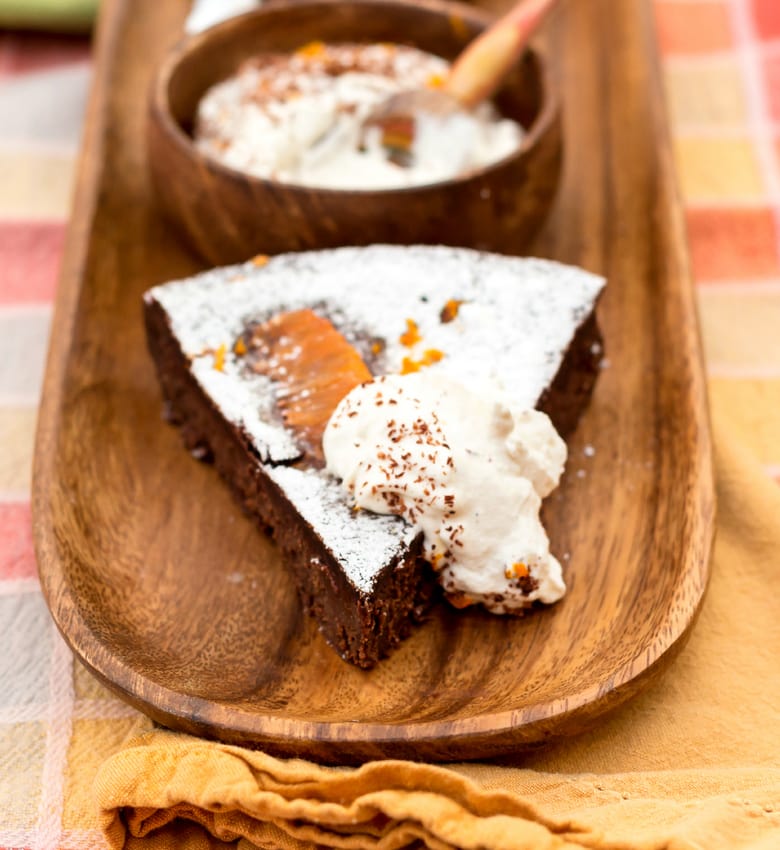 orange chocolate truffle cake on a plate with whipped cream