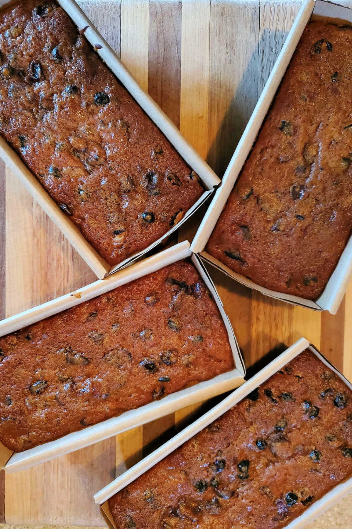 An overhead shot of 4 loaves of fruitcake in loaf pans.