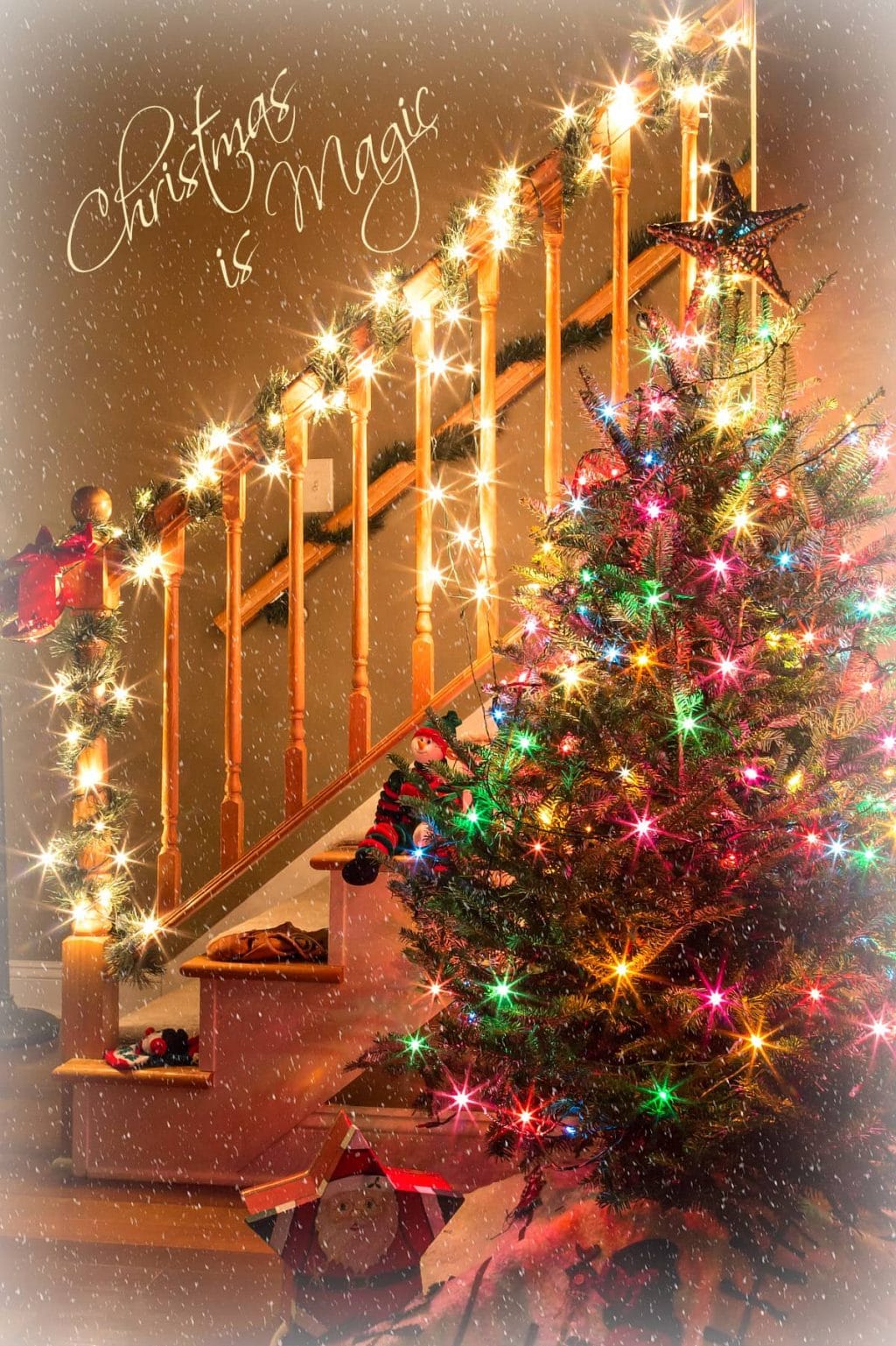 Christmas is Magic image with white fairy lights wrapped around a stair banister, and a lit Christmas tree.
