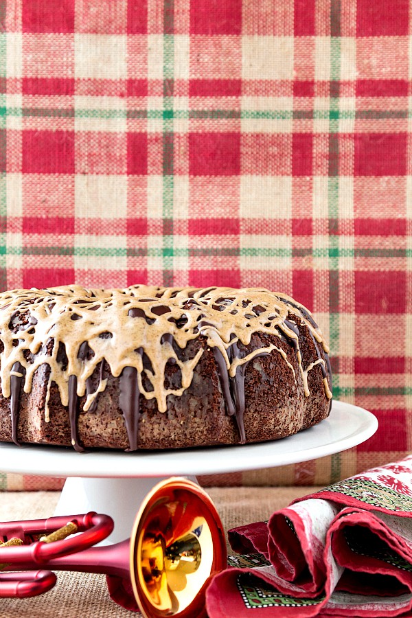 A glazed Chocolate Espresso Pound Cake on a footed white cake plate.