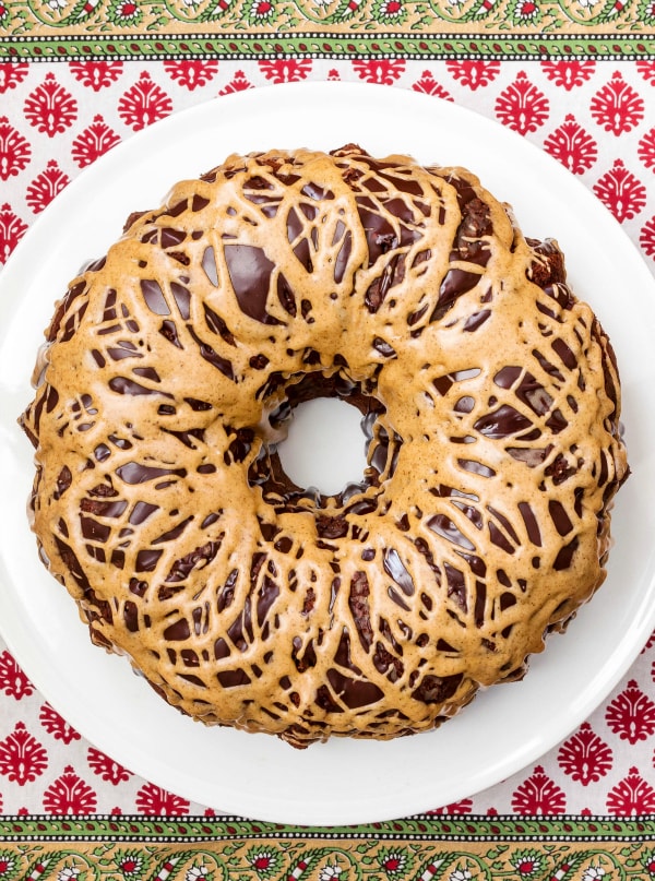 A whole glazed Chocolate Espresso Pound Cake on a white platter.