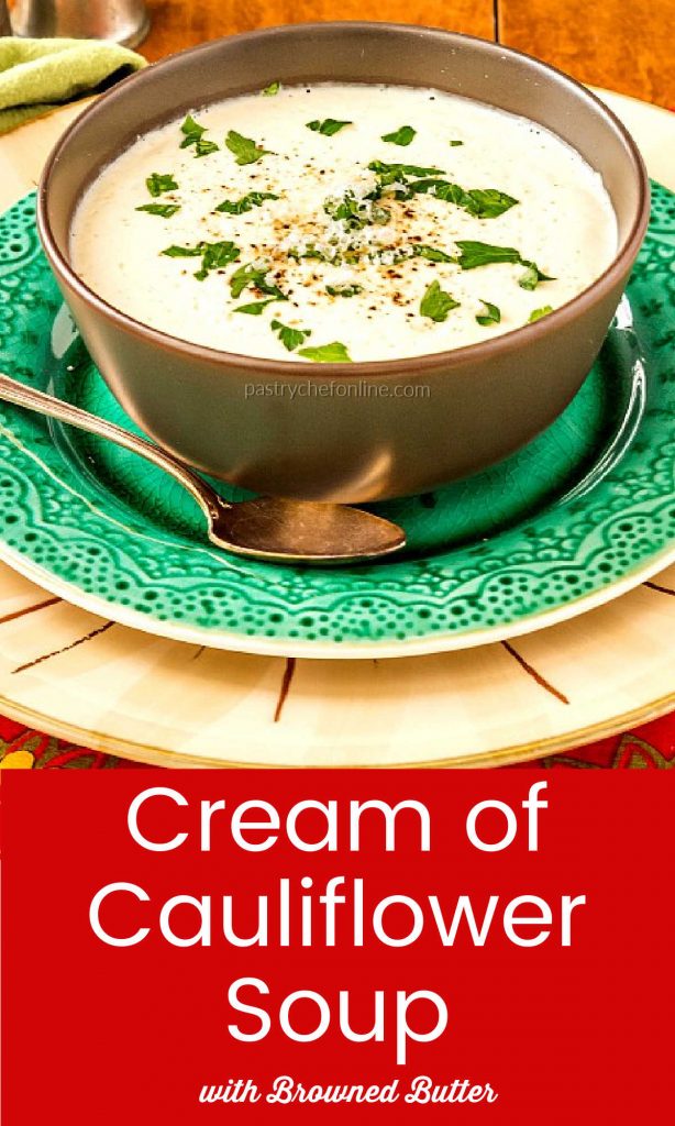 white soup in a brown bowl. Text reads "cream of cauliflower soup with brown butter"