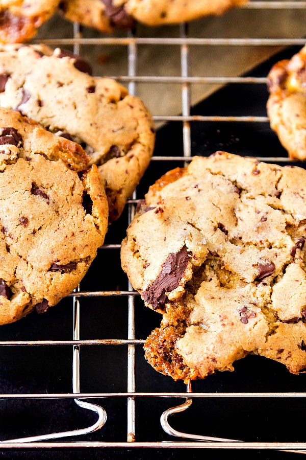 Close up of a cookie showing chocolate chunks and some melted honeycomb candy.