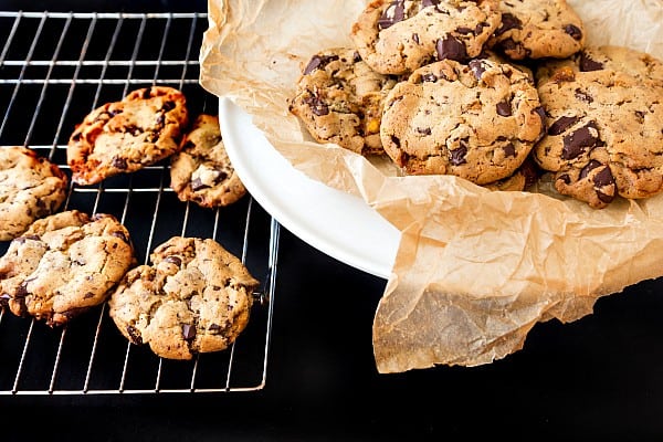a cooling rack of honeycomb chocolate chunk cookies and a plate of cookies