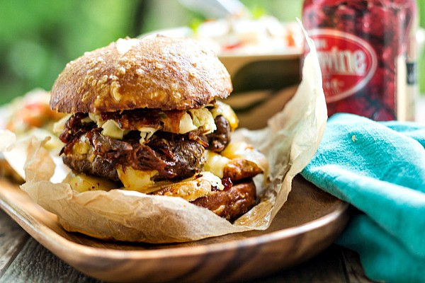 The got to be NC burger on waxed paper next to a cheerwine soda.