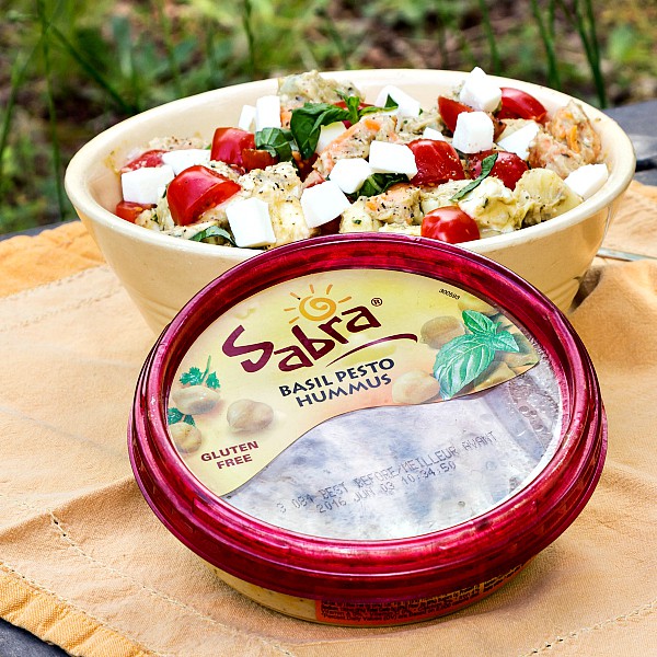 Enjoy this light and bright tortellini caprese salad. Sabra's Basil Pesto Hummus makes the perfect dressing base. Just add cooked tortellini, grape tomatoes, fresh mozzarella and basil and you are in business! Enjoy this pasta salad recipe for National Hummus Day on May 13 or whenever you need a light bite for your Unofficial Meal! | pastrychefonline.com