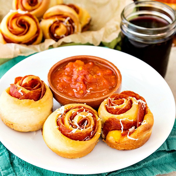 3 spicy pepperoni pinwheels on a plate ready for serving.