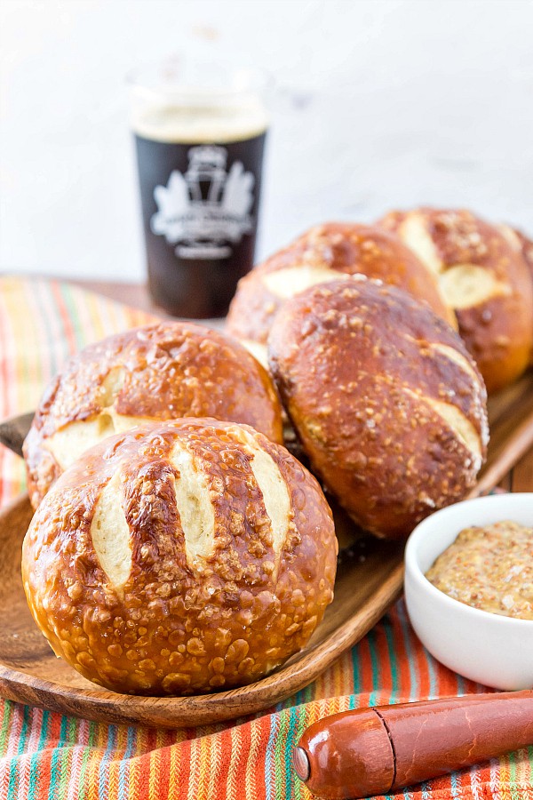 More pretzel buns ready for serving with a dark beer in the background.