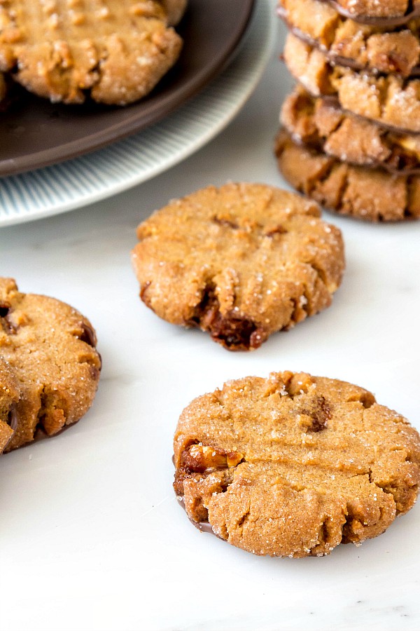 Close up of triple peanut butter cookies with hints of chocolate spread on the bottoms.