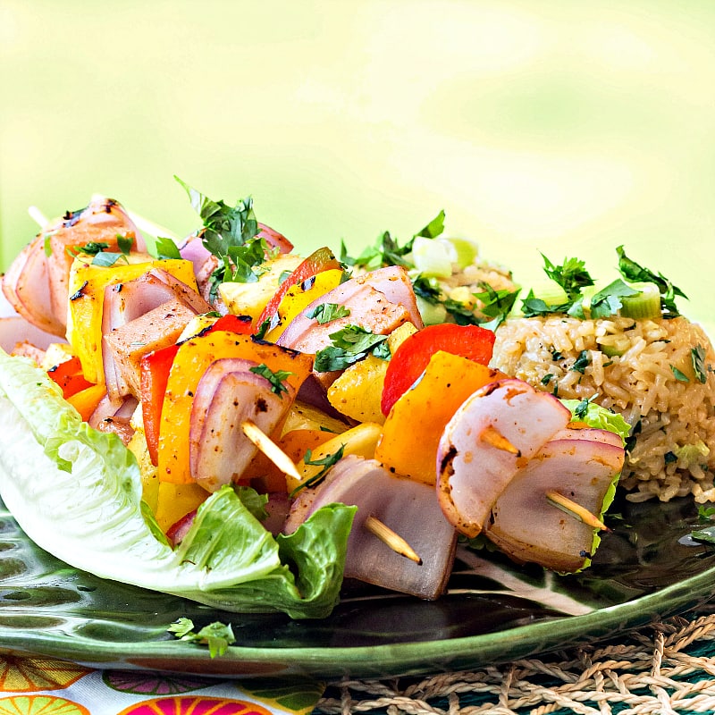Bring the luau to your home with my Hawaiian Pineapple Ham Skewers with Sweet and Hot Pineapple Rice featuring Tracy's Gourmet Aloha Kick Dressing and Marinade! Kabobs are great either grilled or cooked inside on a grill pan, so it's always the right weather for this healthy and fun recipe! #sponsored | pastrychefonline.com