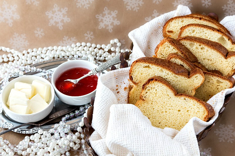 toasted thick slice of bread on a glass plate with butter and jam