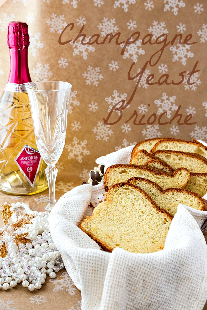 a basket with sliced champagne yeast brioche and a bottle of champagne in the background