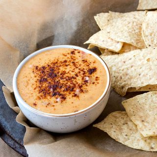 spicy queso dip in a white bowl