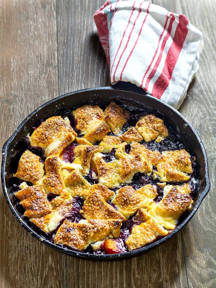 Cast iron pan with baked blueberry peach pandowdy.