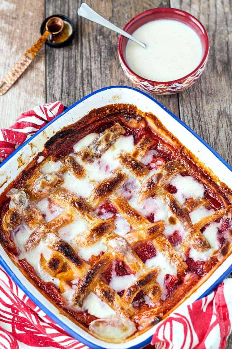 A cooling pan of strawberry peach sonker with lattice crust in a square baking dish.