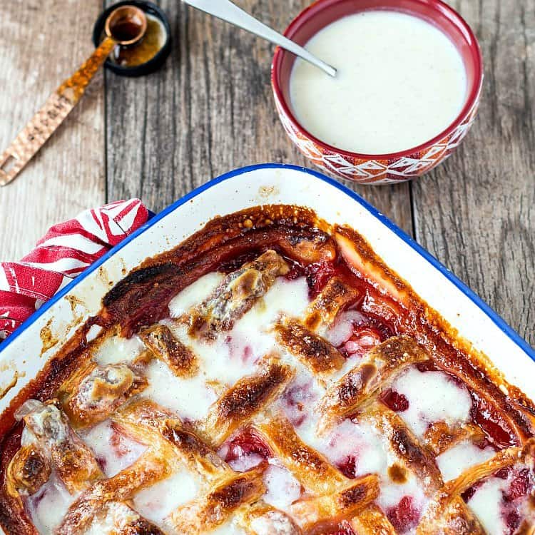 A casserole with fruit cobbler with lattice crust.