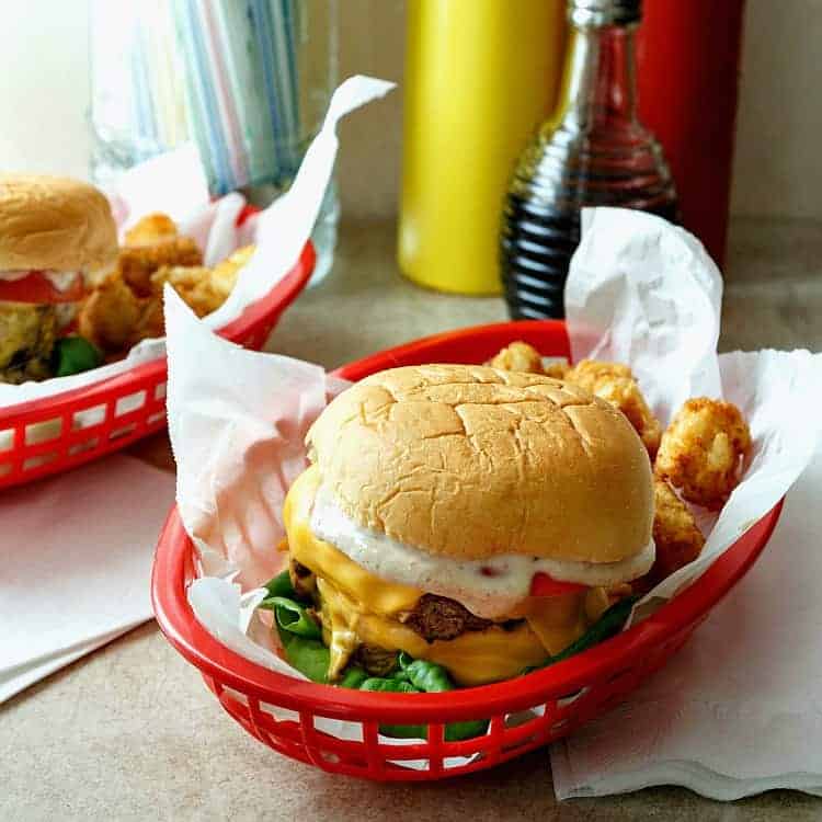 Calling all fans of the movie Grease, grab your best girl or guy and make this copycat Double Polar Burger with Everything, just like Danny Zuko ordered at Frosty Palace. This is an old-school burger recipe featuring simple ingredients and a ton of flavor. #progressiveeats | pastrychefonline.com