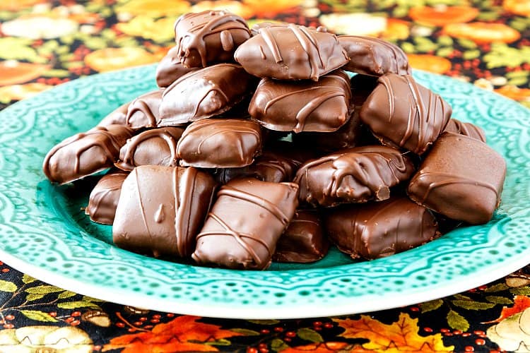 Plate of piled up chocolate-covered homemade Butterfingers candies.
