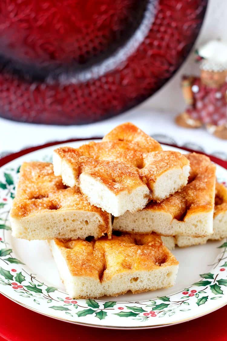 Holly rimmed plate stacked with Moravian sugar cake.