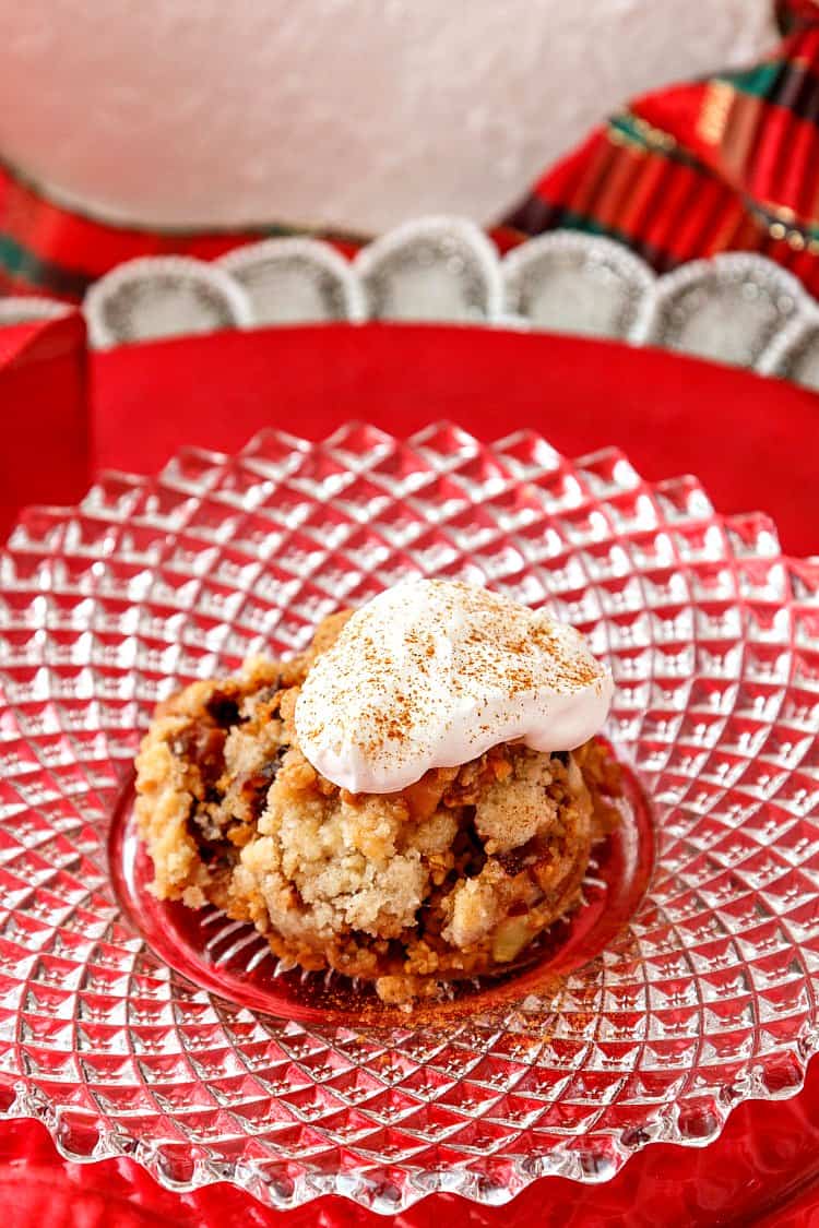 A glass plate on a red background with baked steel cut oats topped with whipped cream.