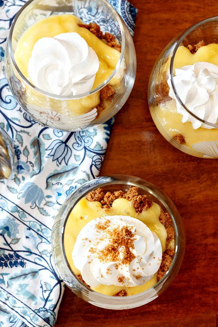 Overhead shot of 3 key lime curd parfaits in clear glasses.