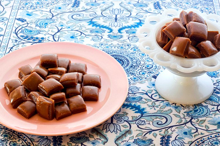 2 groups of squares of butterscotch-  one a pink plate and the other in a white bowl all on a blue background.