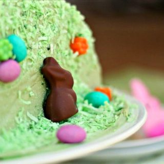 close up of side of green Easter cake decorated with a chocolate bunny