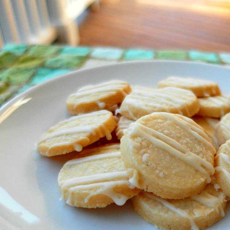 a white plate with small round cookies piled on it