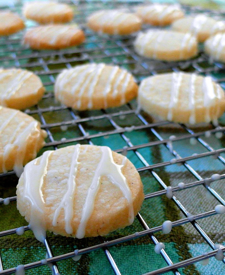 round cookies on a rack with zigzags of white icing on them