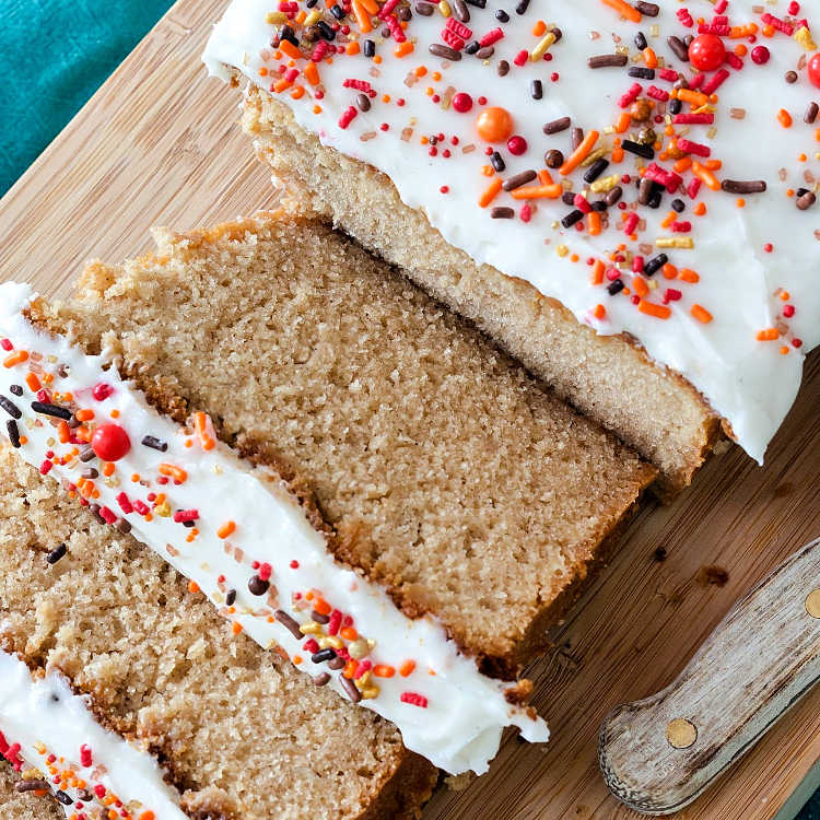 Slices of brown sugar cinnamon pound cake with thick white glaze and sprinkles.