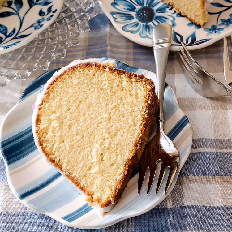 a slice of pound cake on a striped plate