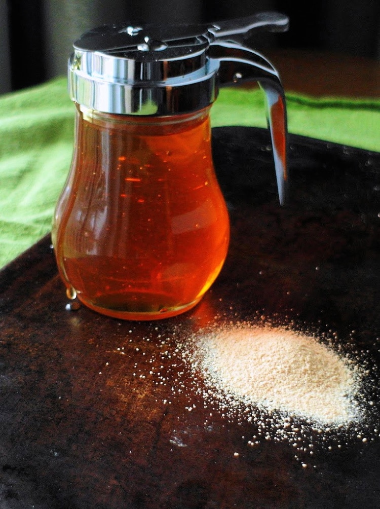a Jar of honey and a pile of dry yeast