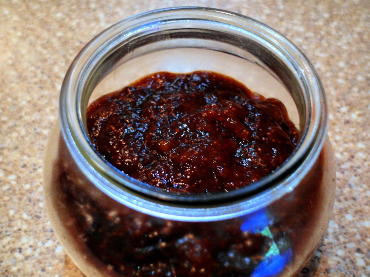 Sweet fig jam with vanilla and black pepper in a clear glass jar.