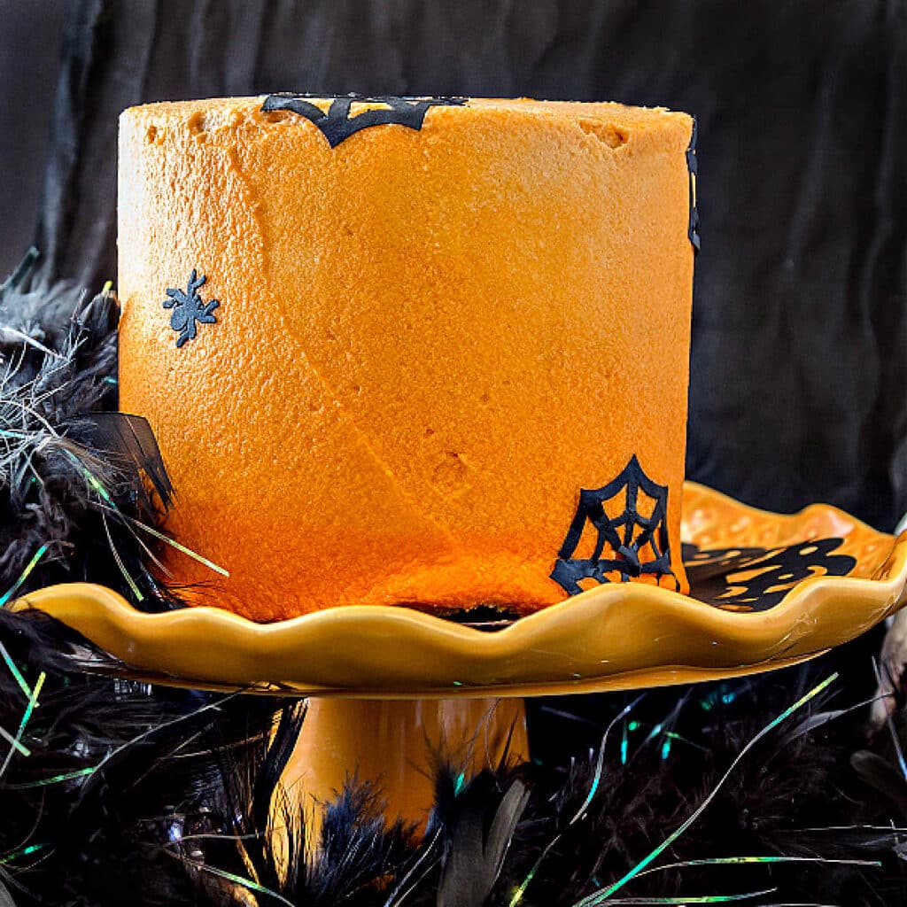 A chocolate Halloween cake decorated with orange ombre frosting.