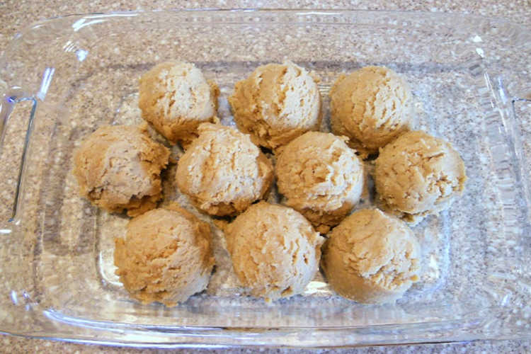 10 scoops of candy dumpling dough in a baking dish.