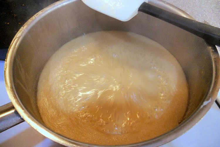 A boiling pot of maple syrup and heavy cream.